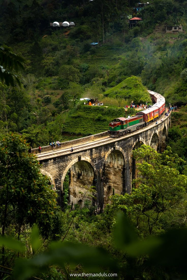 Train crossing a stone bridge through Sri Lanka’s green hill country